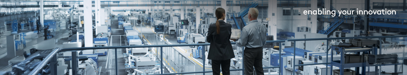 two engineers overlooking factory with robotics assembly line