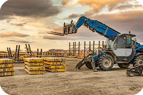 Forklift on a construction site, preparing to raise construction parts